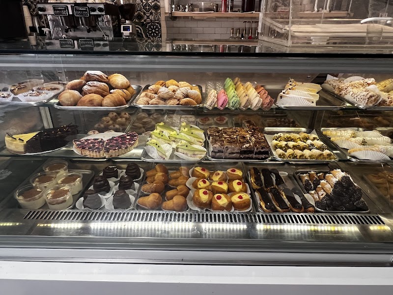 Pastry case filled with cannoli, eclairs, tiramisu and Italian cookies