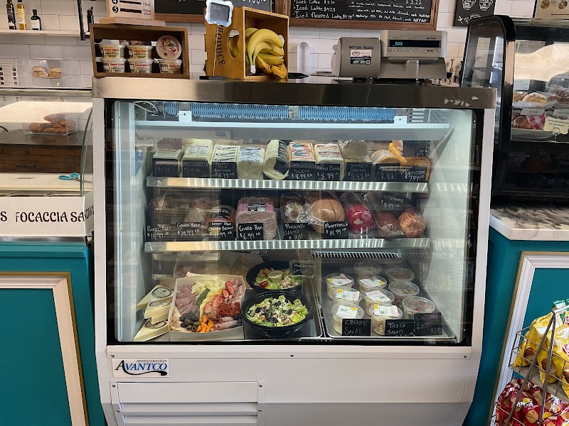 Deli case with cured meats, cheeses and fresh salads
