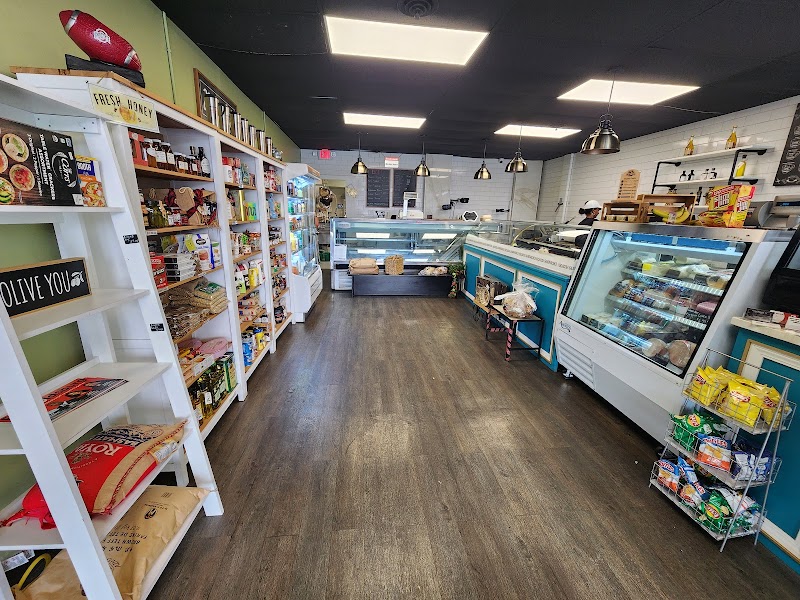 Inside Asmarina Deli and Cafe, with stocked shelves and deli cases